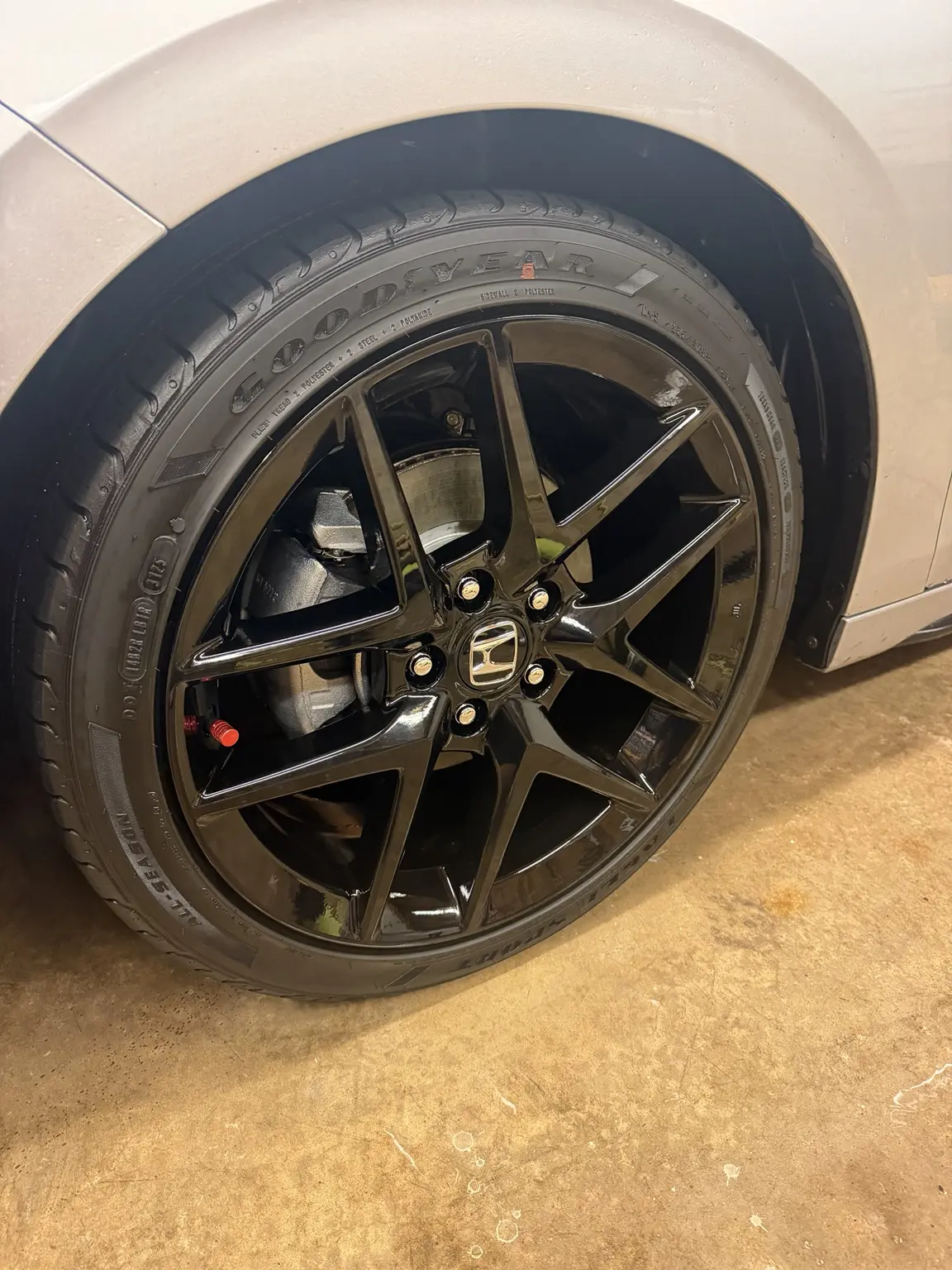 Black Honda wheel after detailing, clean and glossy