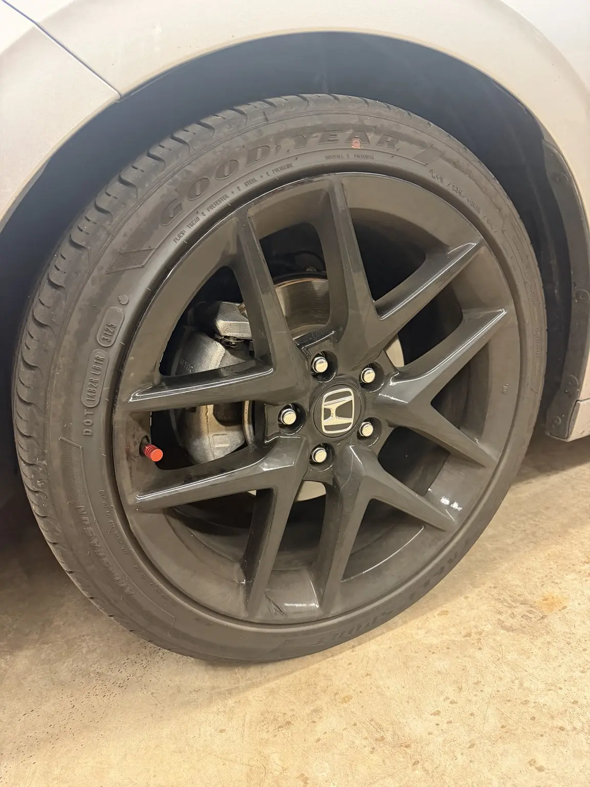 Black Honda wheel before detailing, with visible brake dust and road grime
